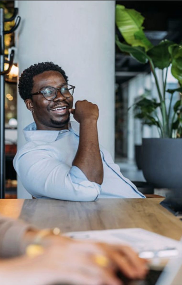 A member smiling at a shared work table